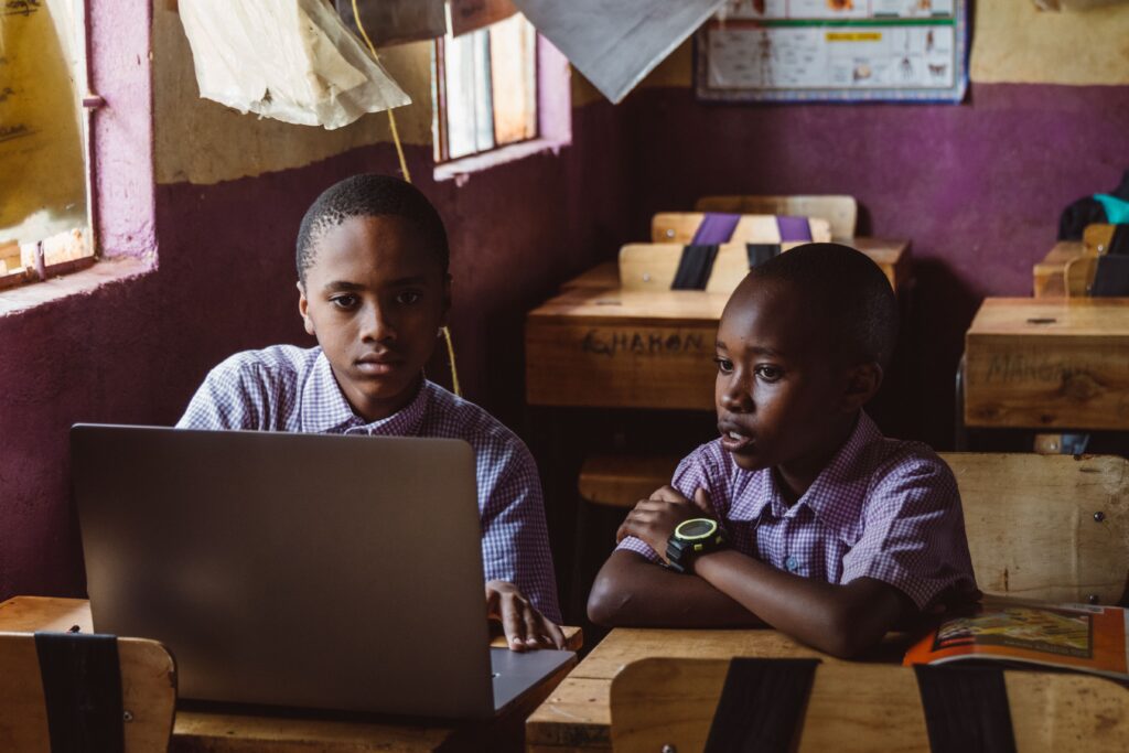 Nigerian student using classroom technology and adaptive e-learning software on a Laptop.